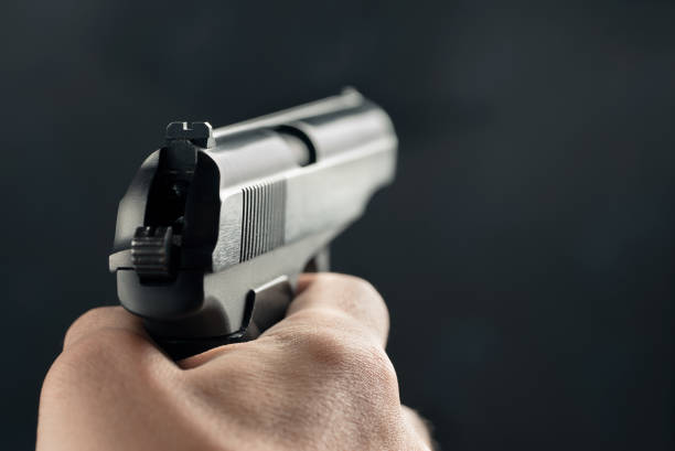 istock Gun in the man's hand. Point of view 1134084248