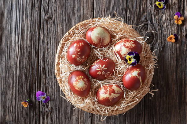 istock Easter eggs dyed with onion peels with a pattern of fresh herbs 1134085324
