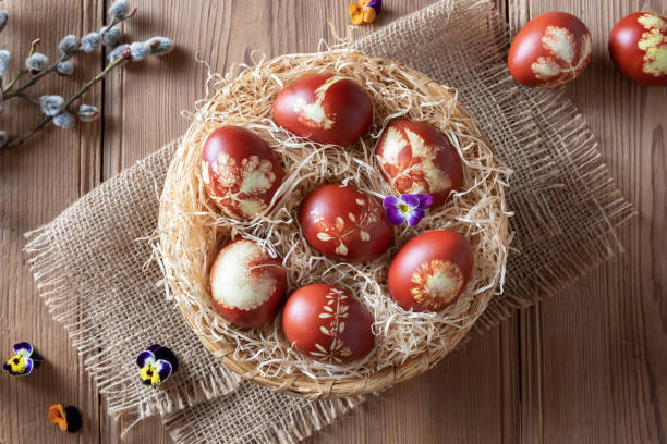 istock Easter eggs dyed with onion peels with a pattern of fresh herbs 1134085336