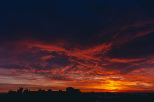 istock Fiery red blood vampire dawn. Amazing warm dramatic fire blue dark cloudy sky. Orange sunlight. Atmospheric background of sunrise in overcast weather. Hard cloudiness. Storm clouds warning. Copy space 1134085869