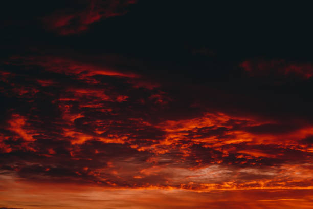 istock Fiery red blood vampire dawn. Amazing warm dramatic fire cloudy sky. Vivid orange sunlight. Atmospheric background of sunrise in overcast weather. Hard cloudiness. Storm clouds warning. Copy space. 1134085873