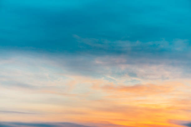 istock Sunset sky with orange yellow light clouds. Colorful smooth blue sky gradient. Natural background of sunrise. Amazing heaven at morning. Slightly cloudy evening atmosphere. Wonderful weather on dawn. 1134085882