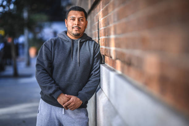 istock Man leaning on brick wall in the city and looking at camera 1134088297