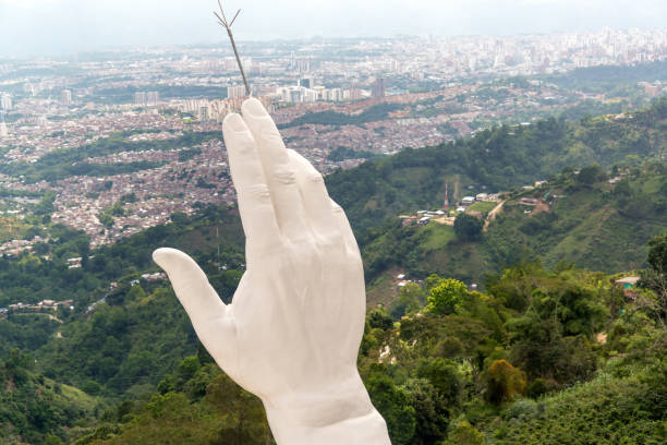 View of the hand of the El Santisimo statue in Floridablanca, Colombia with Bucaramanga visible in the background