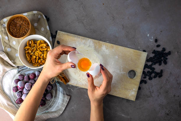 istock Baking ingredients on gray background. Female hands. 1134092350