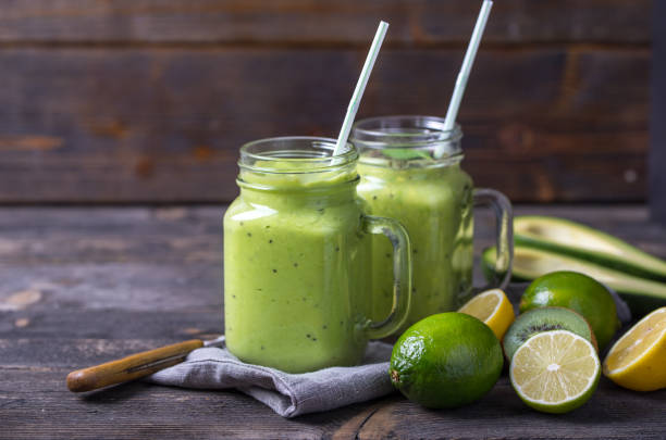 istock Green smoothie on green background made by avocado, lemon and kiwi. 1134093323