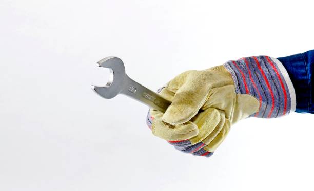 Tool in hand Work glove holds tool maschinenbau stock pictures, royalty-free photos & images