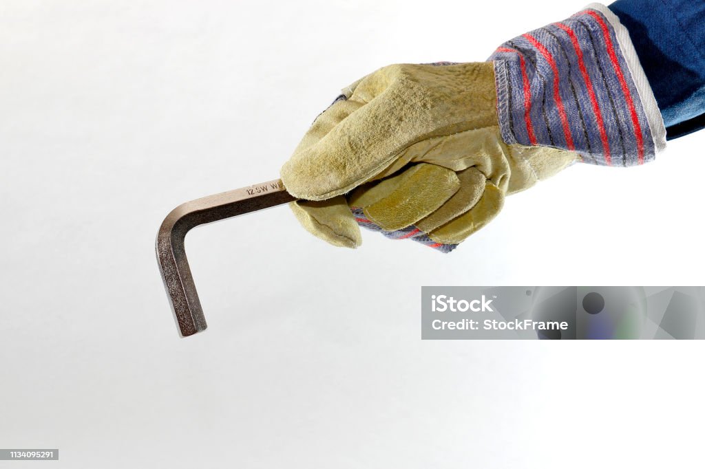 Tool in hand Work glove holds tool Adjustable Stock Photo