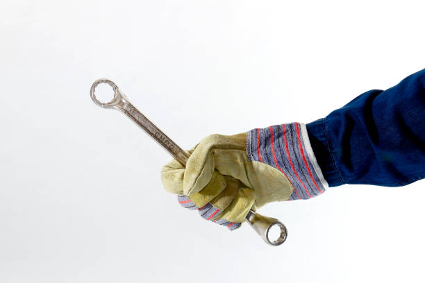 Tool in hand Work glove holds tool maschinenbau stock pictures, royalty-free photos & images