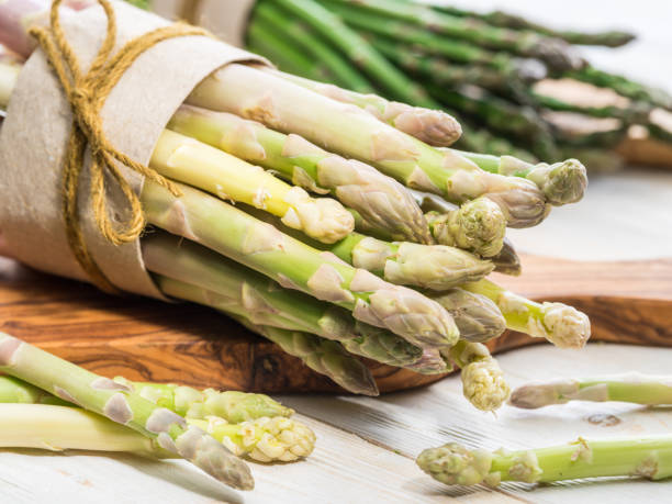 istock Bundles of green and white asparagus. 1134096378
