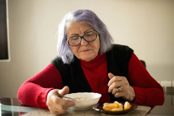 istock Elderly woman eats sitting at the table. 1134097997