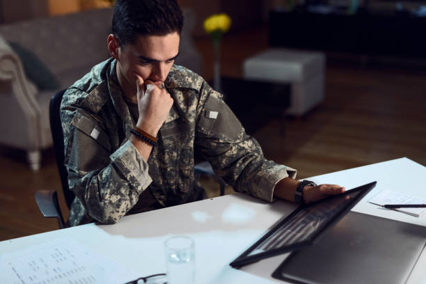 us military soldier looking at national flag in picture frame and feeling nostalgic. - depression sadness usa american flag imagens e fotografias de stock