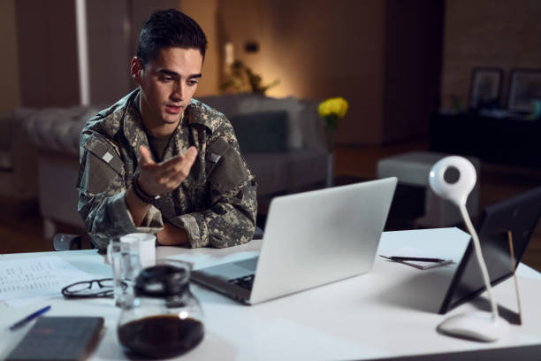 istock Young army soldier making video call over laptop. 1134099583
