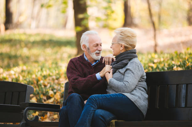 istock Happy autumn senior couple on park bench 1134101100