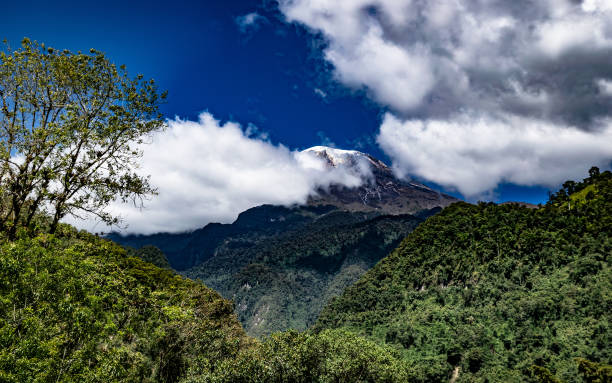 Beautiful view of the Tolima snowy peak B Beautiful view of the Tolima snowy peak contrasted in a bright blue sky with few clouds taken from the outskirts of Ibague Tolima tolima stock pictures, royalty-free photos & images