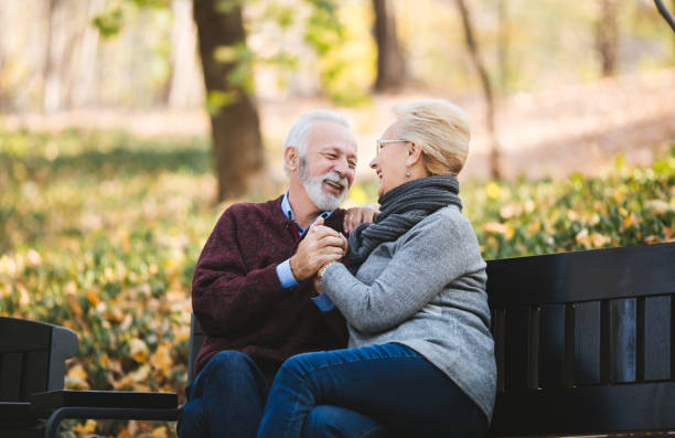 istock Happy autumn senior couple on park bench 1134101135
