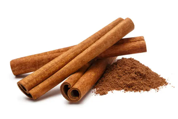 Photo of Cinnamon sticks on white