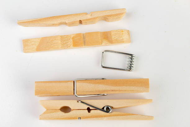 A row of clothespins dipped in a blue solution as part of a crafting or experimental process. Vibrant colors and organized setup create a visually engaging composition.
