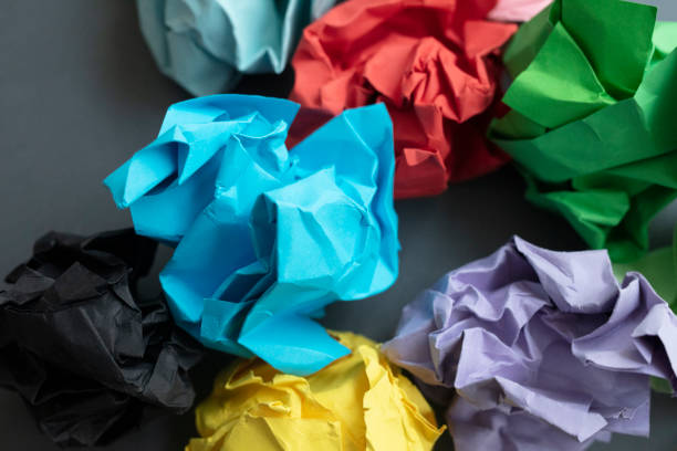 istock Multicolored Crumpled paper balls on black background. 1134104890