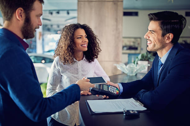 istock Couple is renting car and paying using mobile phone 1134104956