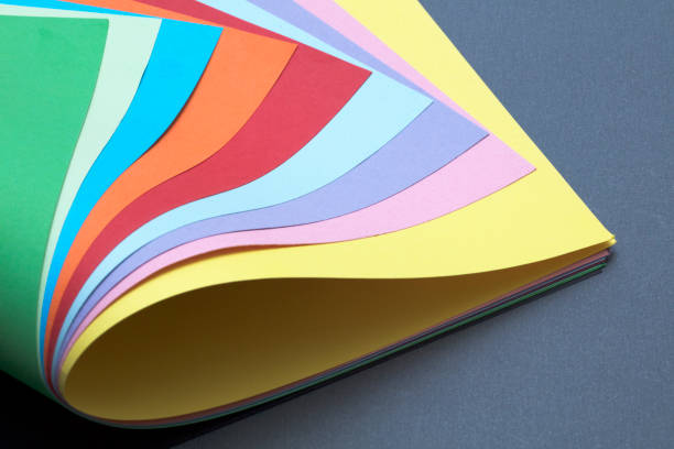 istock Abstract colored papers on blue, pink and orange background. 1134106248