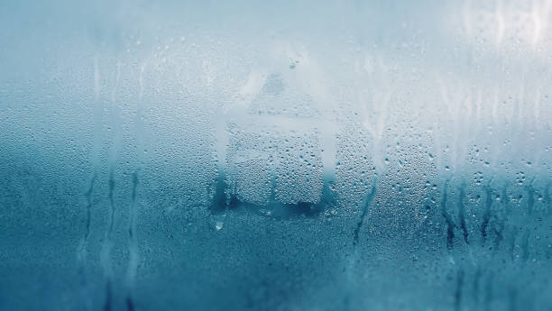 istock Dripping Condensation on the clear glass window. Water drops. Abstract background texture. Detail of moisture close up 1134106359