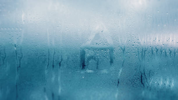 istock Dripping Condensation on the clear glass window. Water drops. Abstract background texture. Detail of moisture close up 1134106363