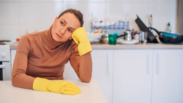 istock Exhausted housewife is wearing protective gloves 1134106617