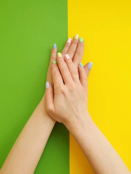 istock female hands manicure on color paper background 1134107496