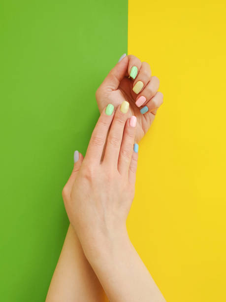 istock female hands manicure on color paper background 1134108648