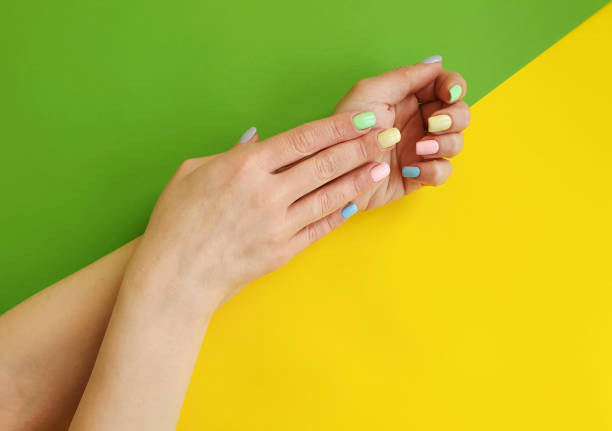istock female hands manicure on color paper background 1134111851