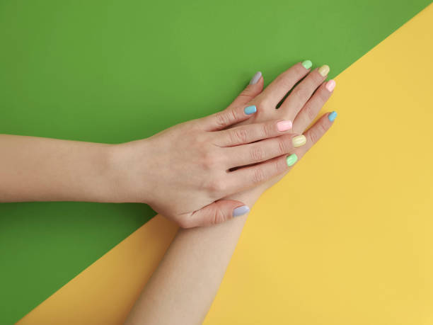 istock female hands manicure on color paper background 1134112134