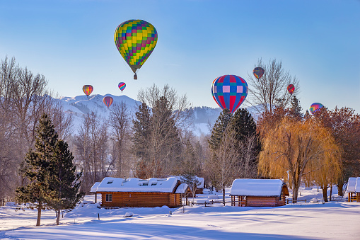 Hot air balloons over snow covered village in Washington state