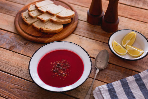 istock Fresh made beetroot soup with bread slices and lemon served in plate, close-up 1134114972
