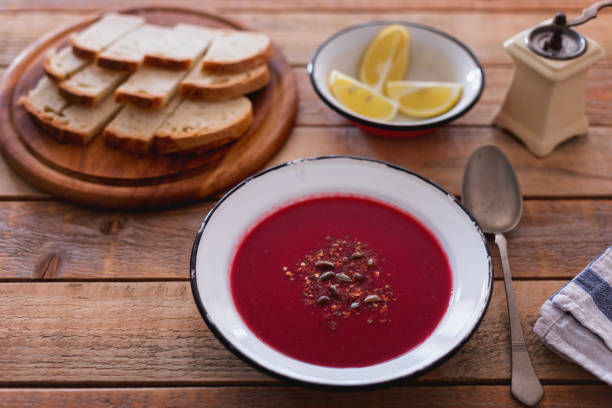 istock Fresh made beetroot soup with bread slices and lemon served in plate, close-up 1134115488