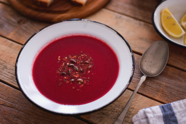 istock Fresh made beetroot soup with bread slices and lemon served in plate, close-up 1134115510