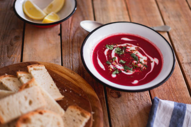 istock Fresh made beetroot soup with bread slices and lemon served in plate, close-up 1134115523