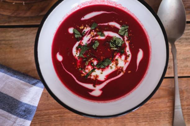 istock Fresh made beetroot soup with bread slices and lemon served in plate, close-up 1134115588