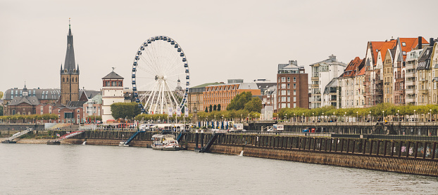 25 October 2018 Germany, Dusseldorf. North Rhine. City center, the embankment of the river. Saray Town Hall and the Ferris Wheel in the fall in overcast weather.