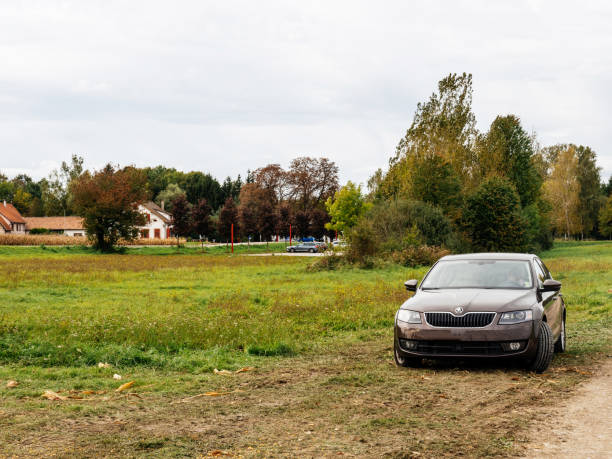 Roppenheim, France - Oct 7, 2017: Skoda Octavia car parked in the open field with female driver talking on the phone inside the car