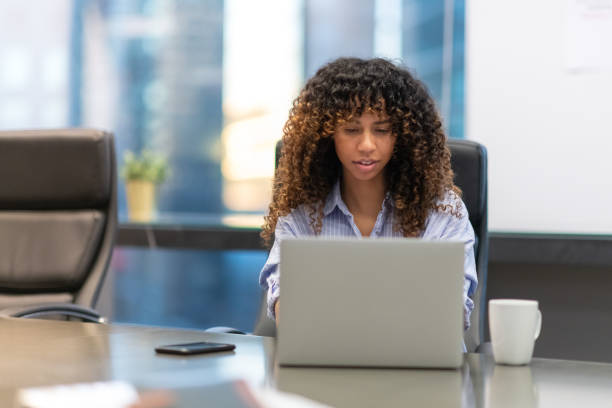 istock Woman concentrates while working on her laptop 1134123227