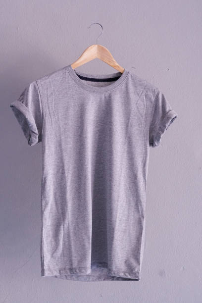 istock Retro fold grey cotton T-Shirt clothes mock up template on gray cement background concept for retail dress shop backdrop, Blank flat lay vintage grey wall plain laundry advertising 1134123281