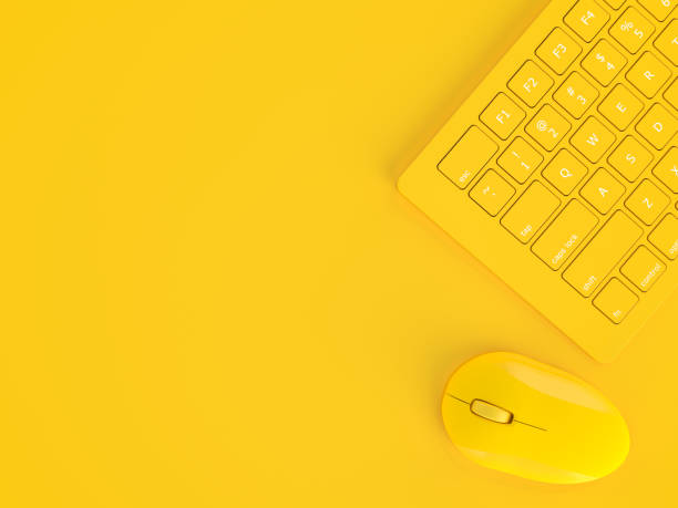 istock Minimal concept. Mouse beside keyboard yellow color 1134123305