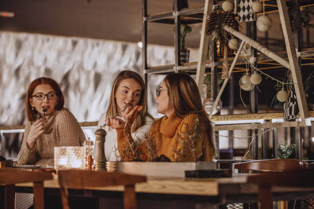 istock Three women eating in a restaurant 1134123386