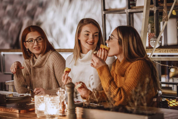 Women tasting delicious pastry