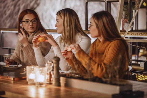 istock Mother and daughters eating in a restaurant 1134123406