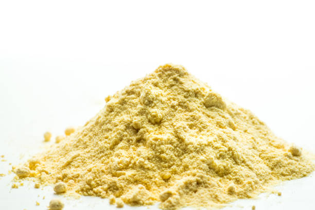 light yellow powder on a white background stock photo