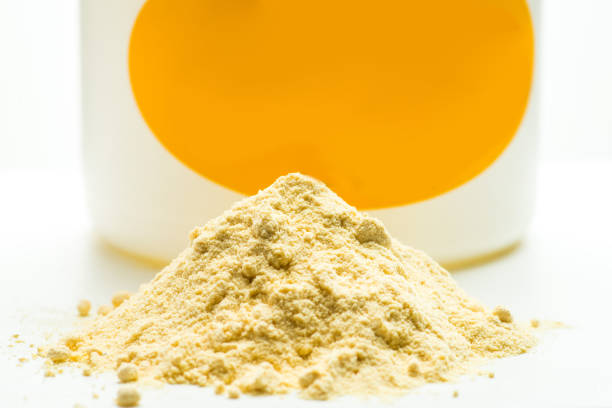 Light yellow powder and can. Soya lecithin powder stock photo