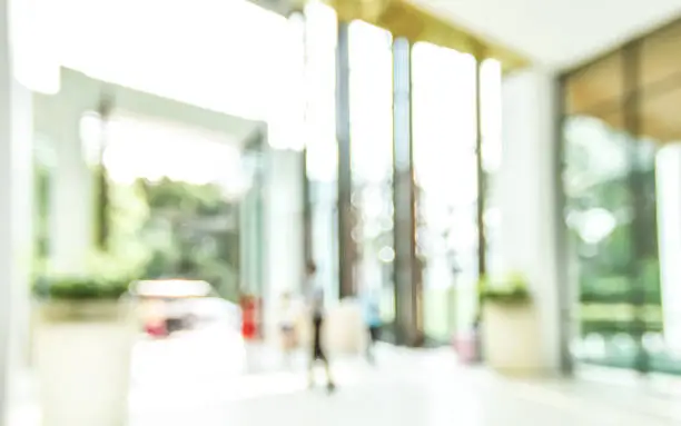 Lobby of resort hotel blur background luxurious entrance hall foyer interior view with reception desk counter, atrium space, entrance doors and glass wall