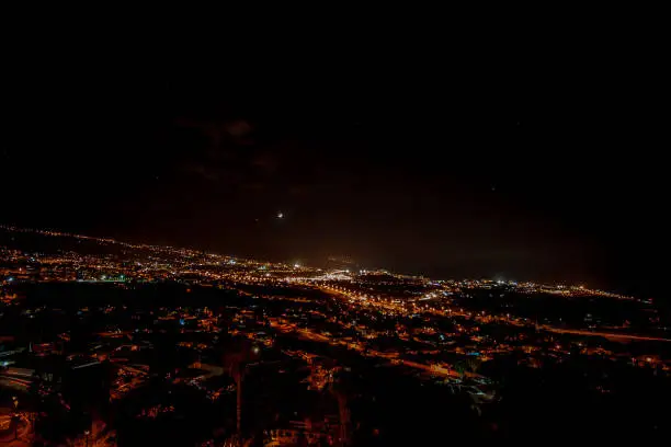 fantastic night view with moon and stars over a city